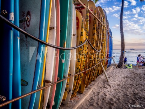 Picture of Colourful surfboards stacked up on Waikiki Beach at sunset